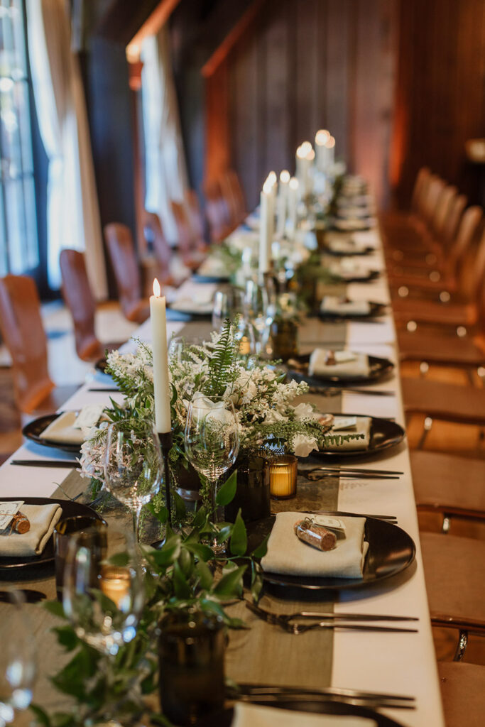 wedding reception layout with florals and candles at table