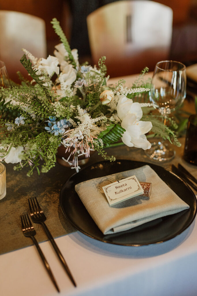 floral centerpiece with flatware and napkins 