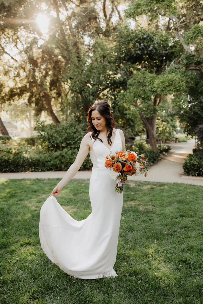 bride holding bouquet with orange tones